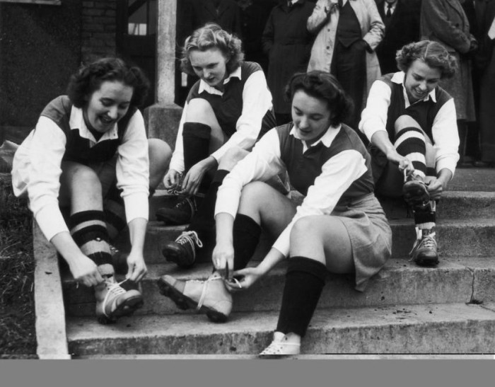 Members of the Butlins Social Club Ladies Football Team get ready for their match against Guys Football Club. From left to right, Margaret Holland, Doris Archer, Vera Holland and Ellen Evans. The game, in aid of National Savings Week is being played at the recreational ground in Wood Green, London, 29th October 1949. (Photo by Fred Morley/Hulton Archive/Getty Images)